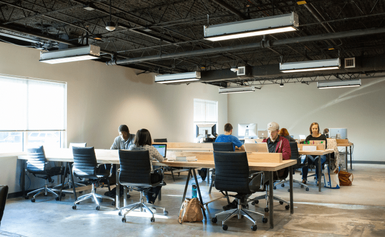 Students sitting in PelotonU office.